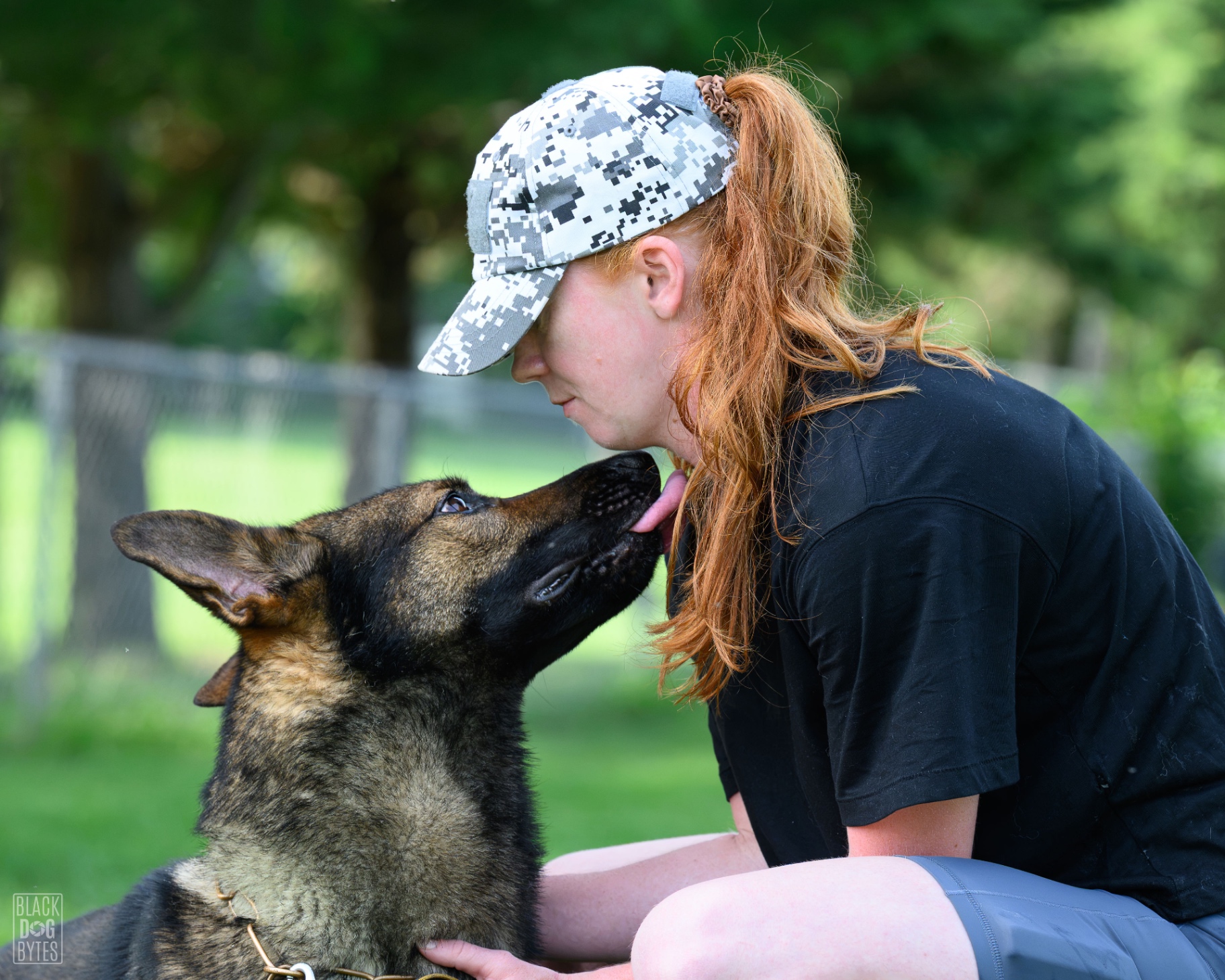 Courtney Vaillancourt nose-to-nose with a German Shepherd